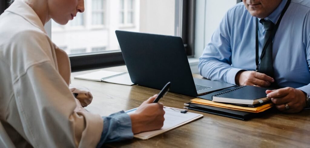 Company liquidation UAE 2026 - business partners signing closure documents in office