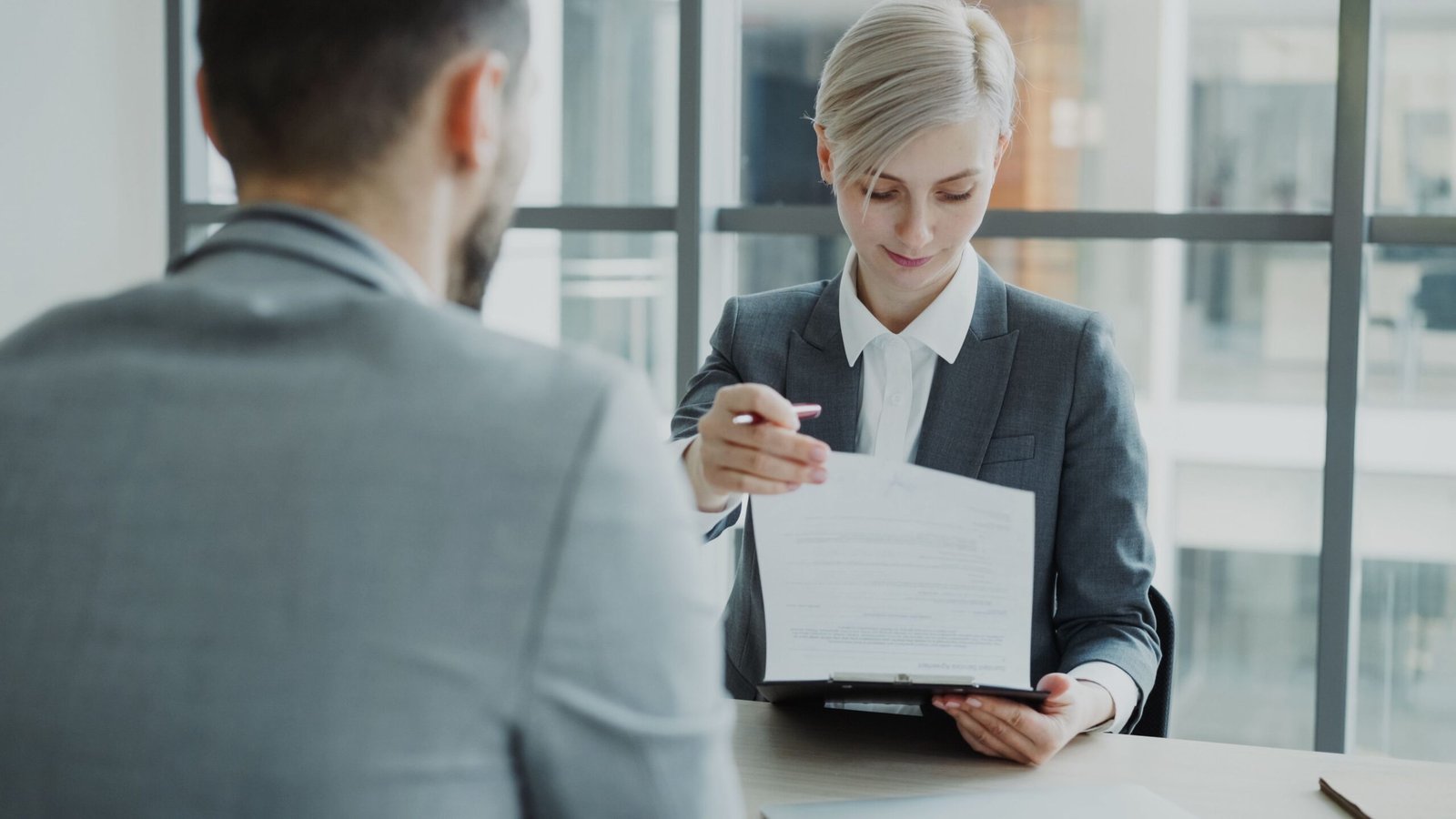 Business professionals reviewing a contract, illustrating UAE Corporate Tax Article 50 General Anti-Abuse Rule compliance