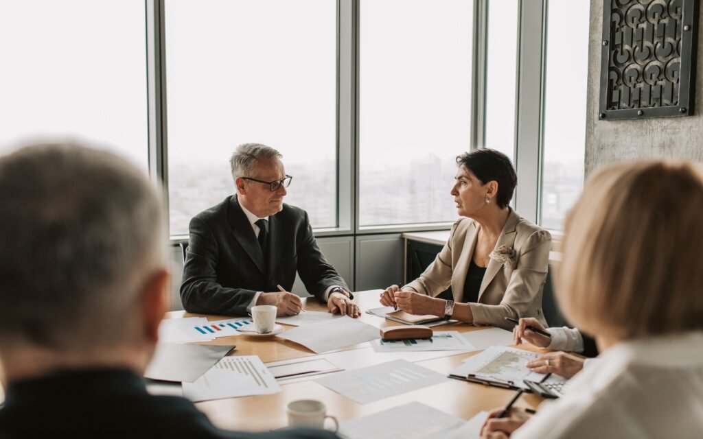 Business team reviewing UAE corporate tax group formation documents in a meeting