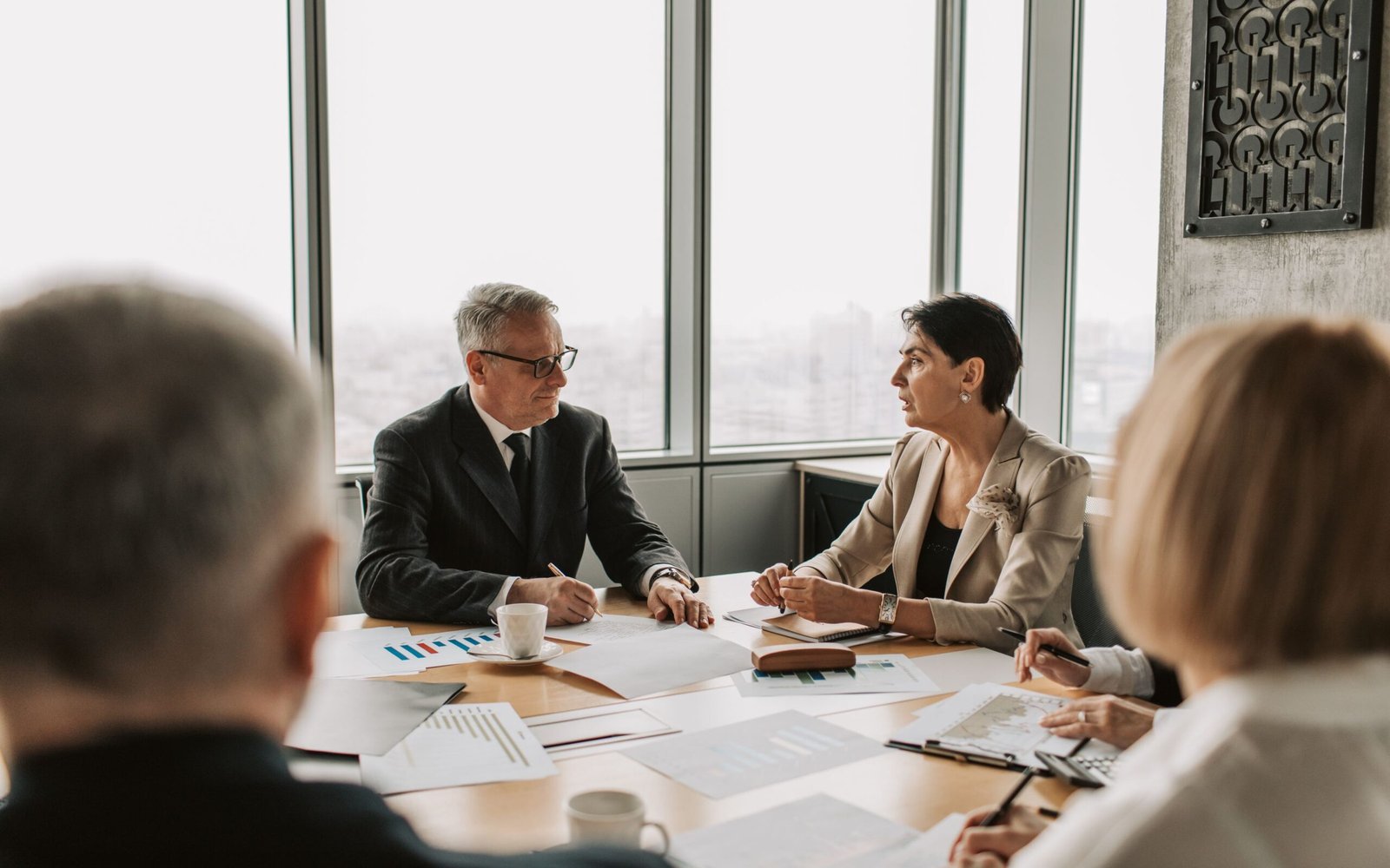 Business team reviewing UAE corporate tax group formation documents in a meeting