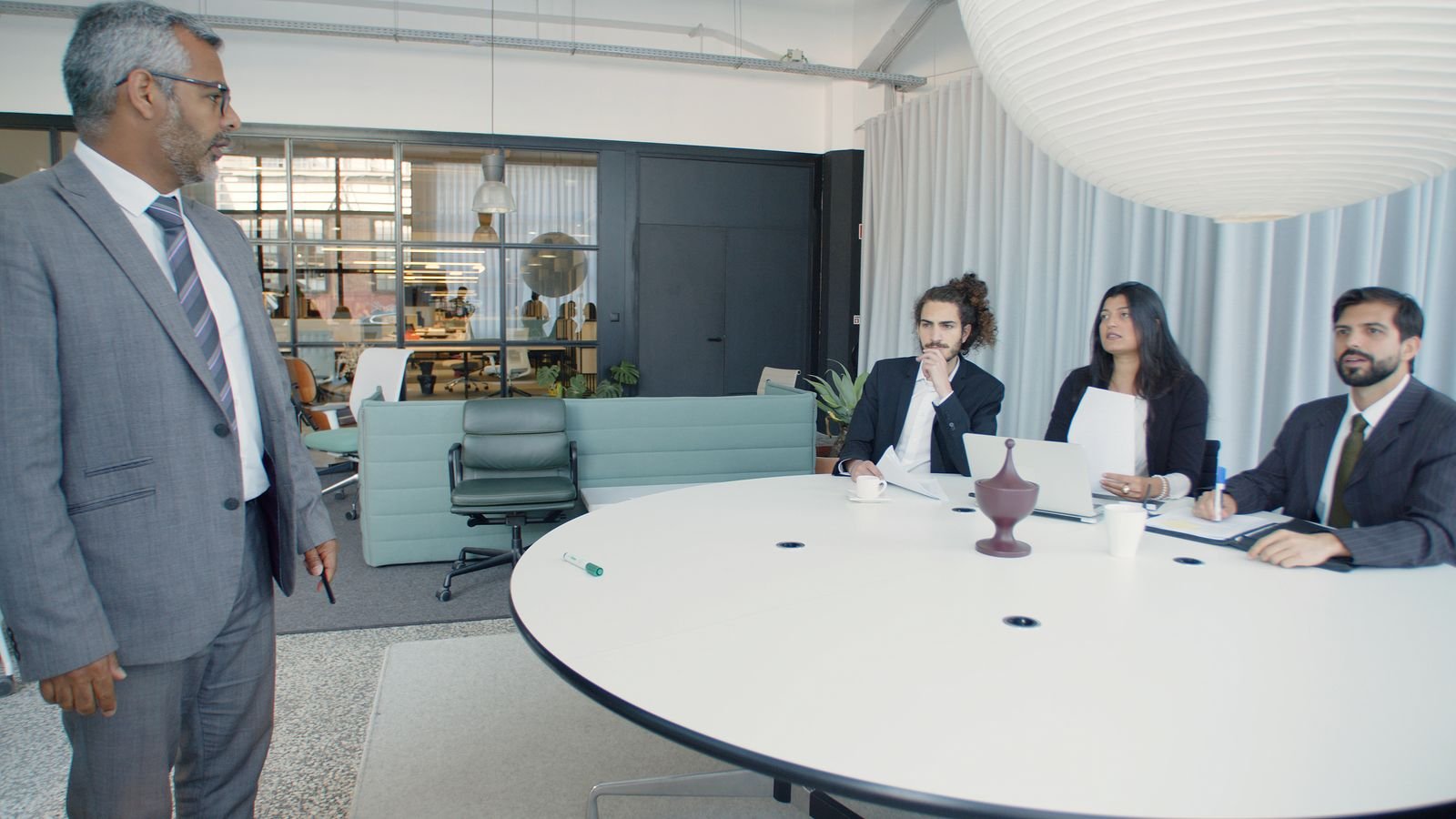Business professionals in a corporate office meeting discussing UAE corporate tax compliance