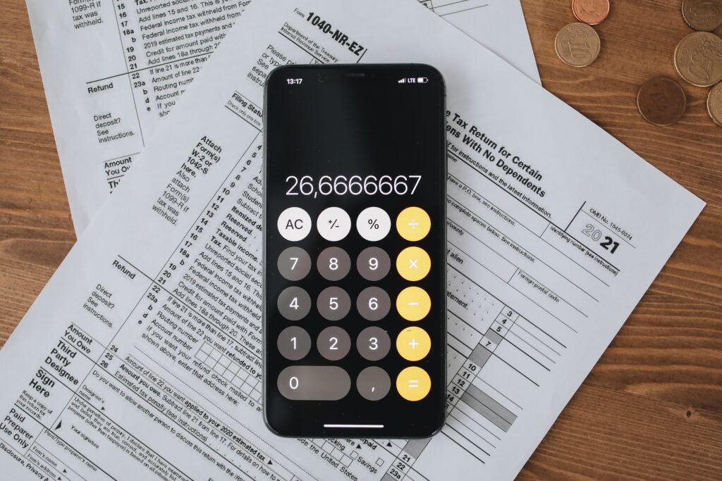 Tax forms and calculator representing UAE Cabinet Decision 129 of 2025 unified corporate tax, VAT, and excise penalty framework