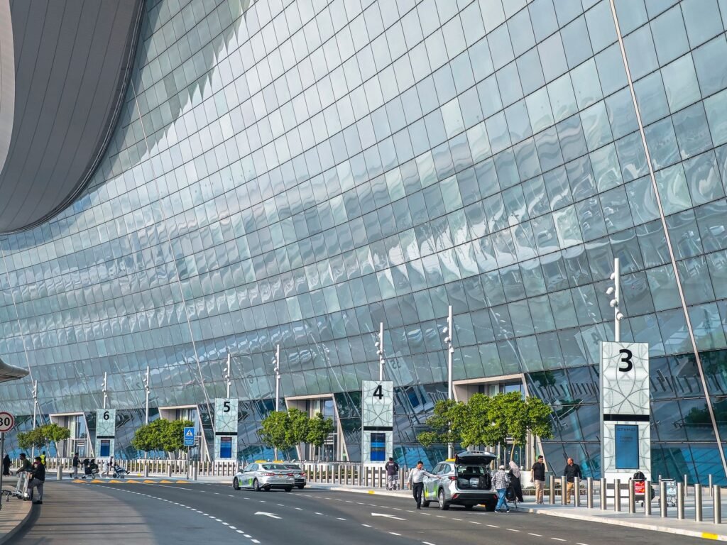 Stunning modern facade of an airport terminal in Abu Dhabi with reflective glass and contemporary design.