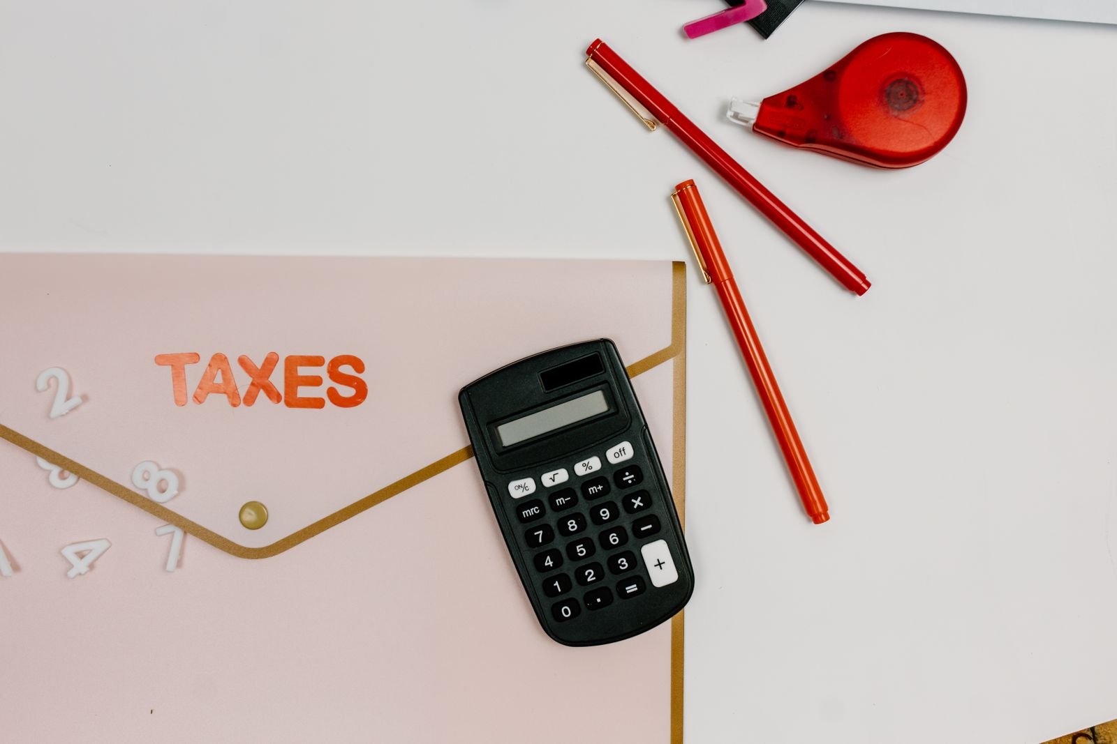 Tax documents, calculator, and paperwork on an office desk illustrating UAE VAT deregistration filing