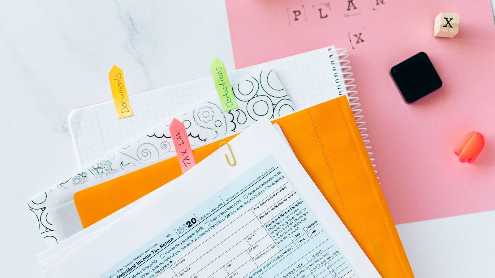 Tax return forms and financial documents on a desk, representing UAE VAT tax group exit adjustments and FTA compliance