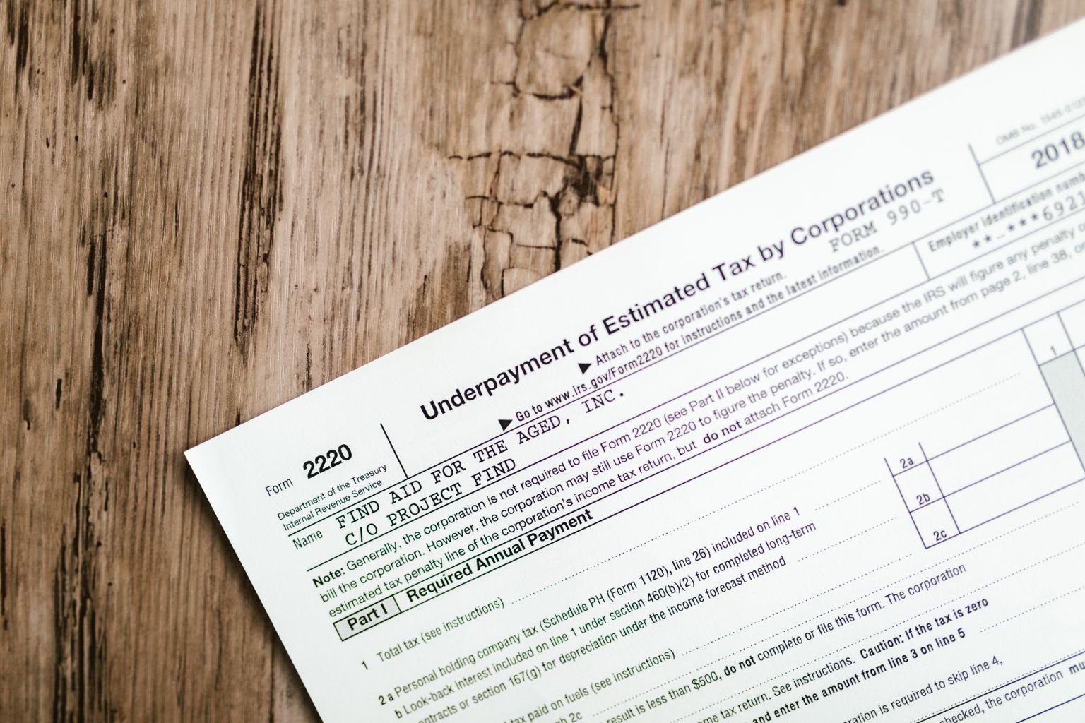 Person reviewing and correcting tax documents at a desk, representing amending a filed UAE Corporate Tax return