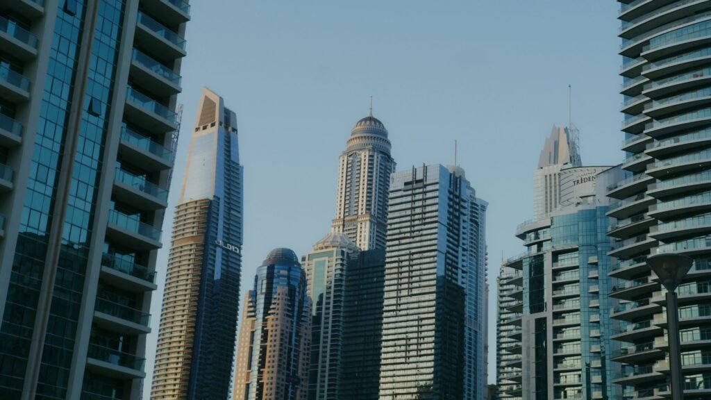 High-rise towers against a clear sky in a UAE business district, representing free zone company setup