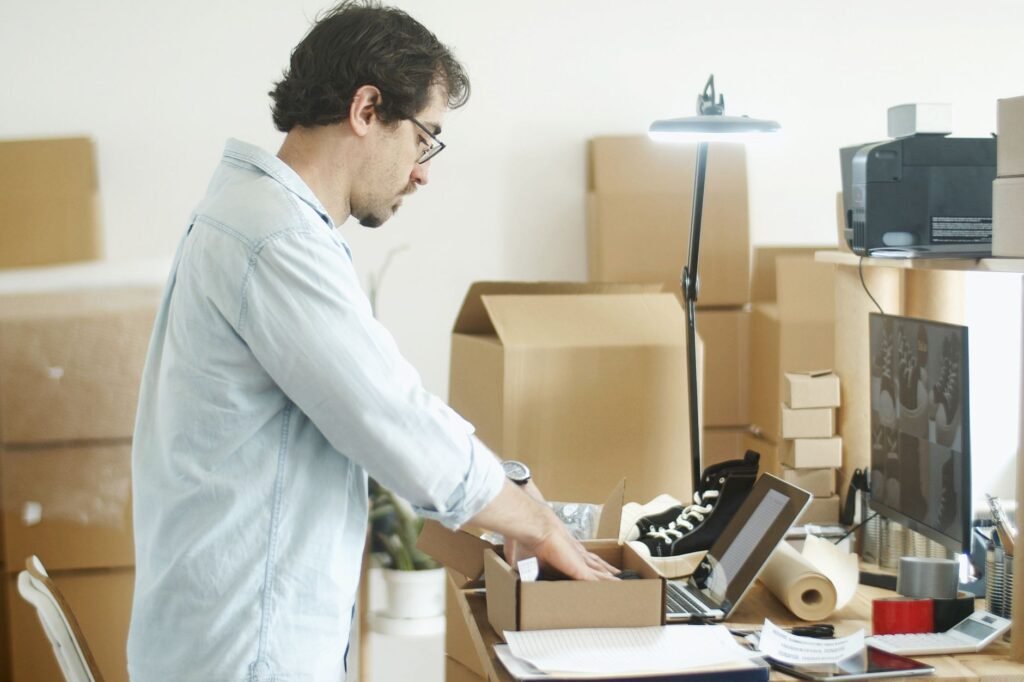 Home-based trader packing products for an online store, representing the Abu Dhabi Tajer licence