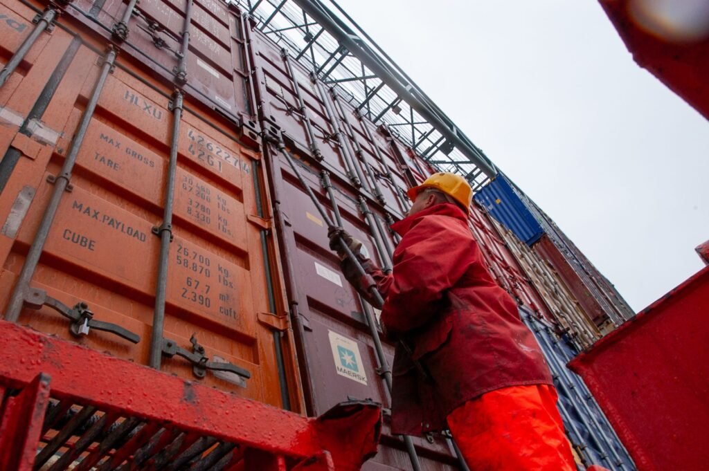 Cargo containers at a shipping port, illustrating import VAT and customs declarations in the UAE