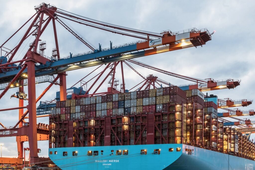 Cargo ship loaded with shipping containers at a commercial port, illustrating UAE VAT zero-rated exports